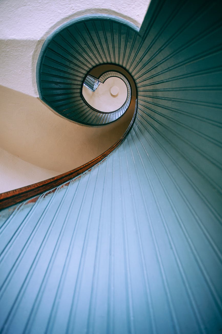 spiral staircase with concrete blue railings